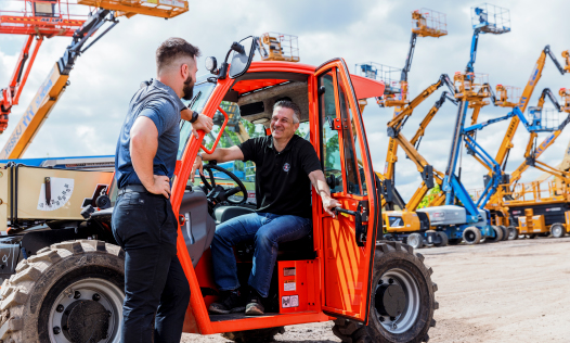 two men looking at tractor